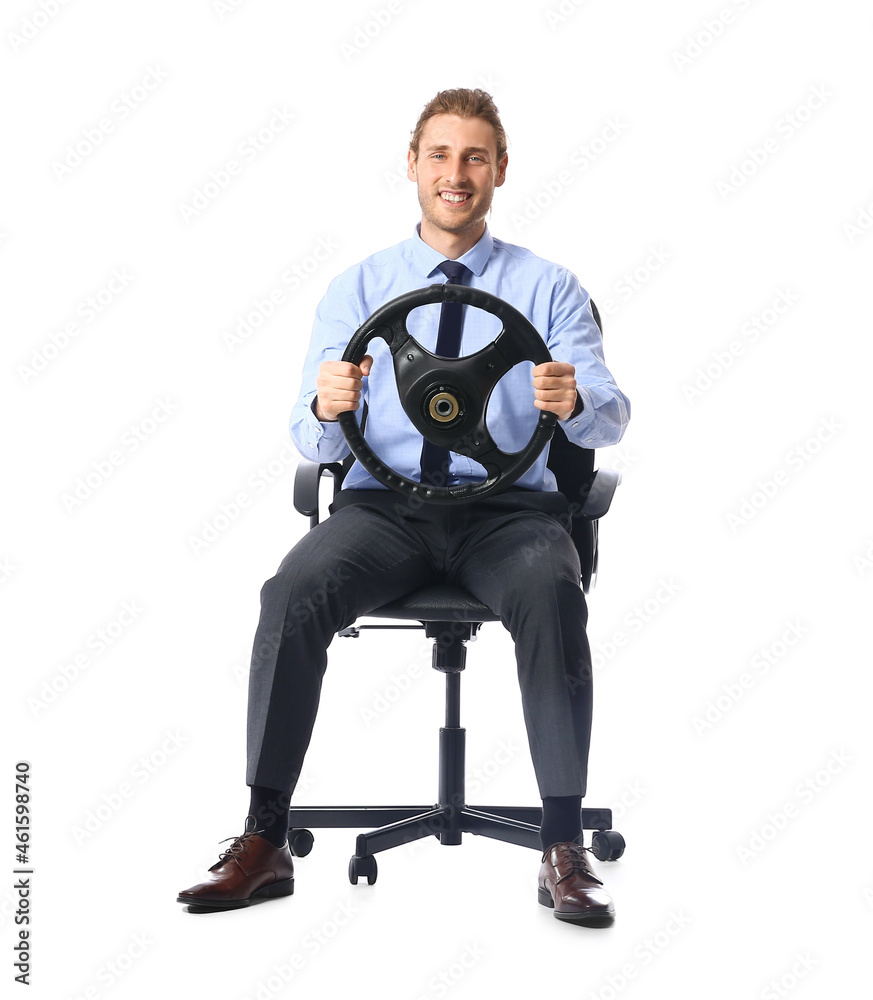 Young man with steering wheel sitting on chair against white background