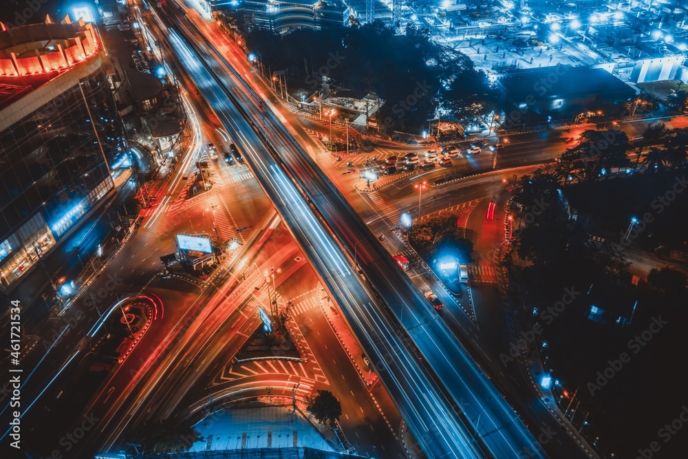 Busy highway road junction in metropolis city center at night . Transportation and infrastructure co