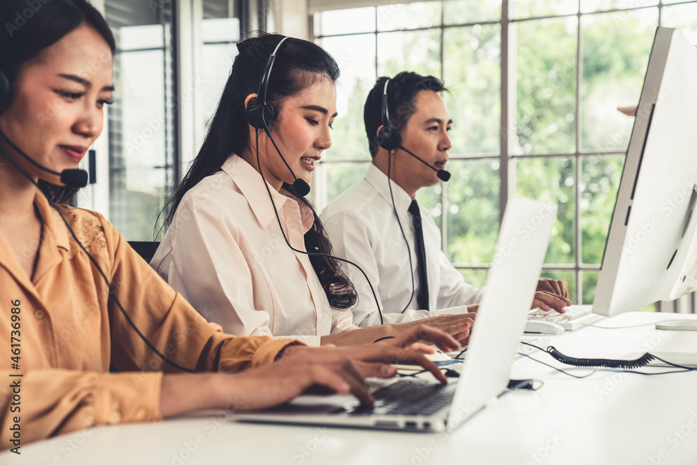 Business people wearing headset working actively in office . Call center, telemarketing, customer su