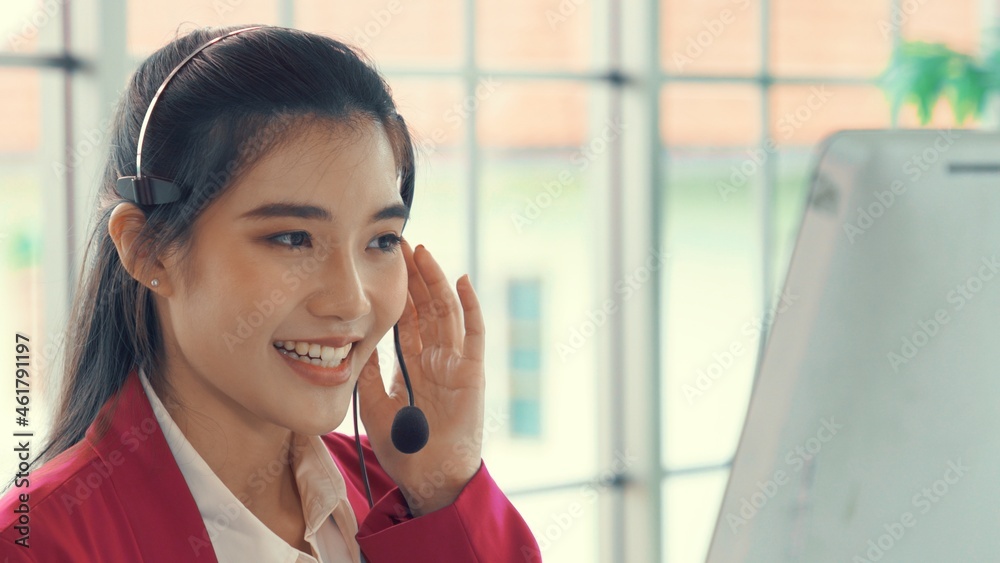 Businesswoman wearing headset working actively in office . Call center, telemarketing, customer supp