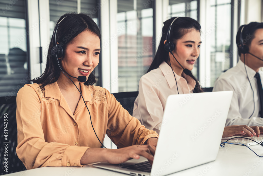 Business people wearing headset working actively in office . Call center, telemarketing, customer su