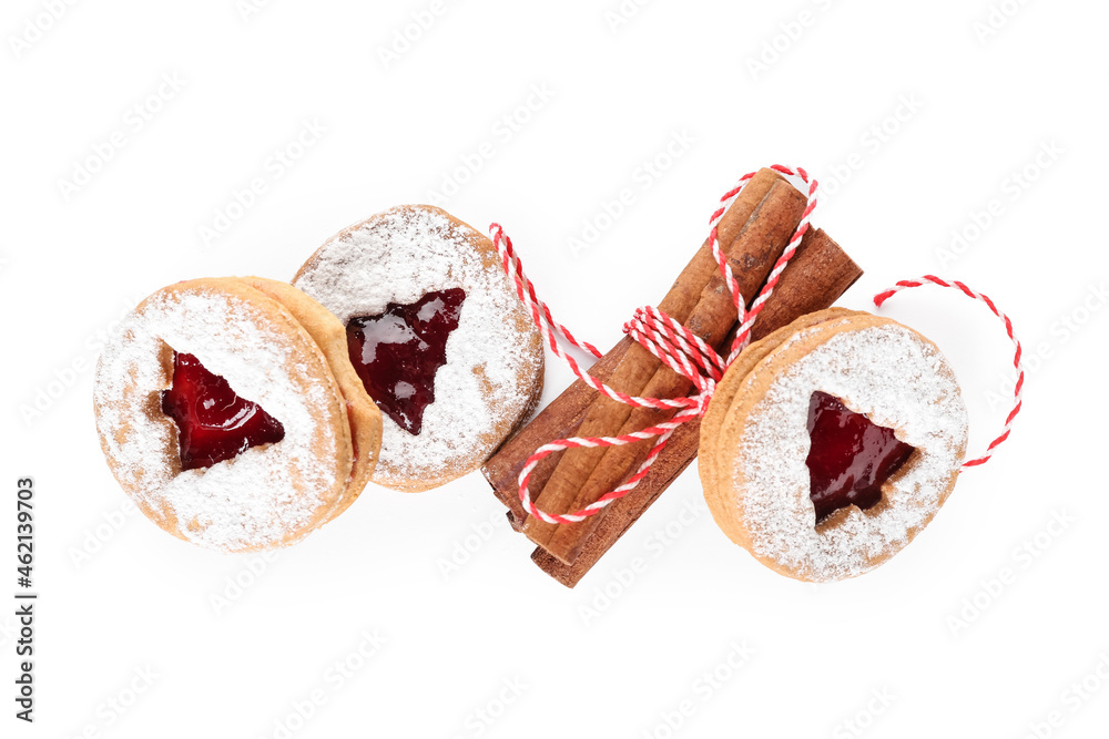 Tasty Linzer cookies with cinnamon on white background