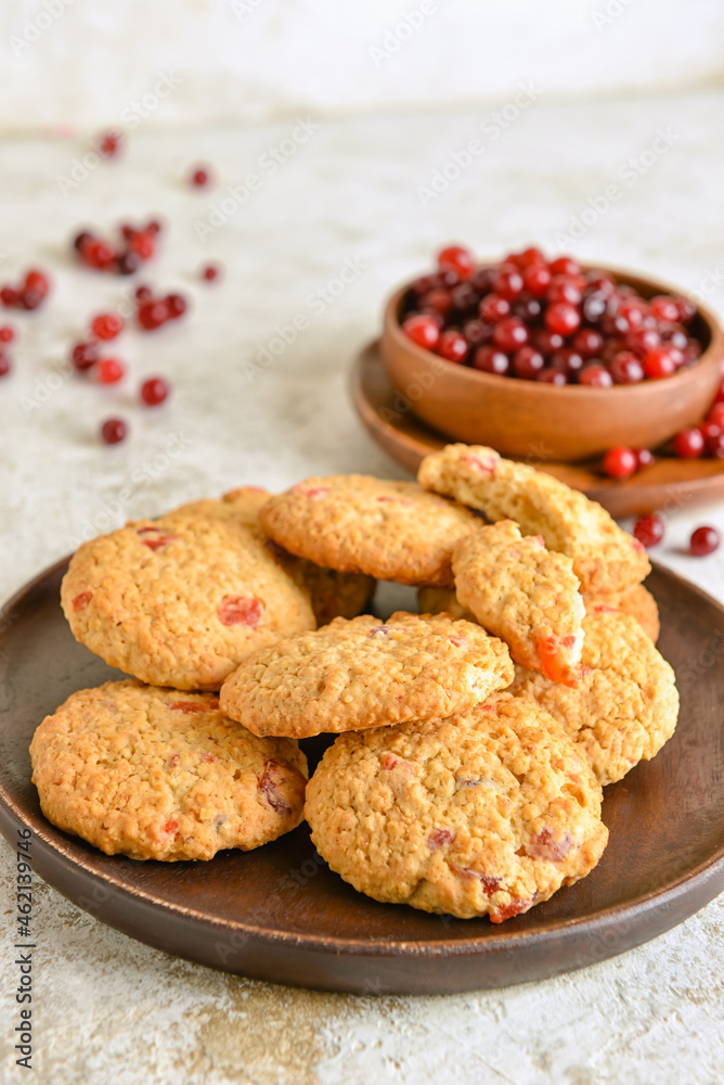 Plate with delicious cranberry cookies on light background, closeup