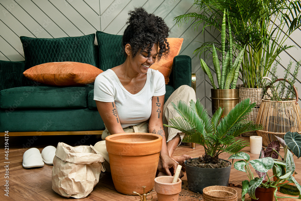 Woman repotting plants in the new normal