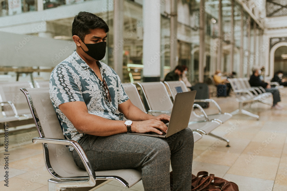 Man sitting at an underground train station