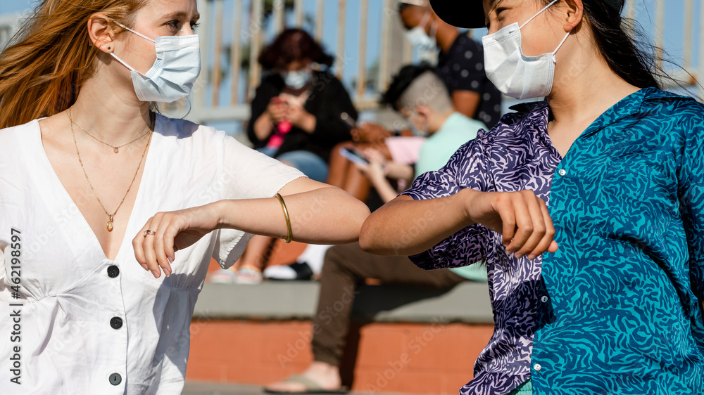 The new normal greeting elbow bump at an outdoors park