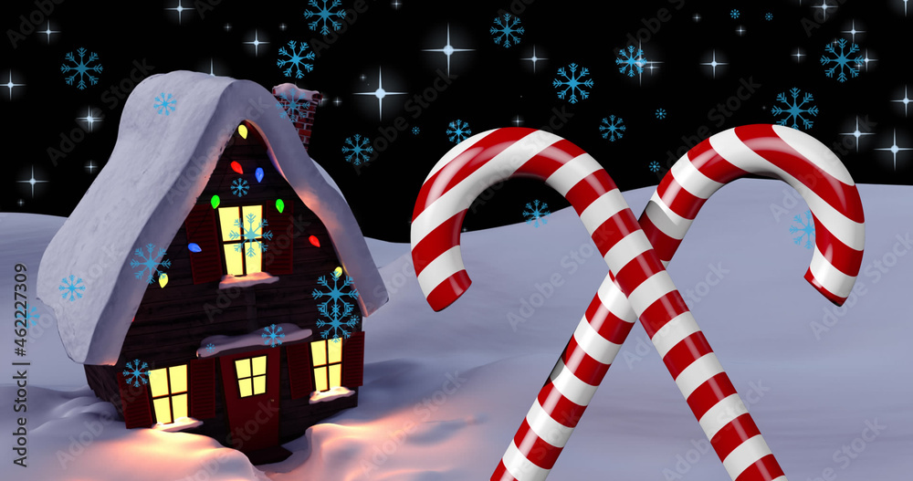 Image of snow falling over christmas candy canes and house on winter landscape