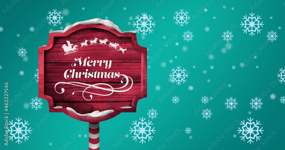 Image of falling snowflakes over wooden sign with merry christmas text