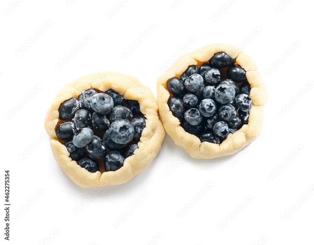 Raw blueberry galettes on white background