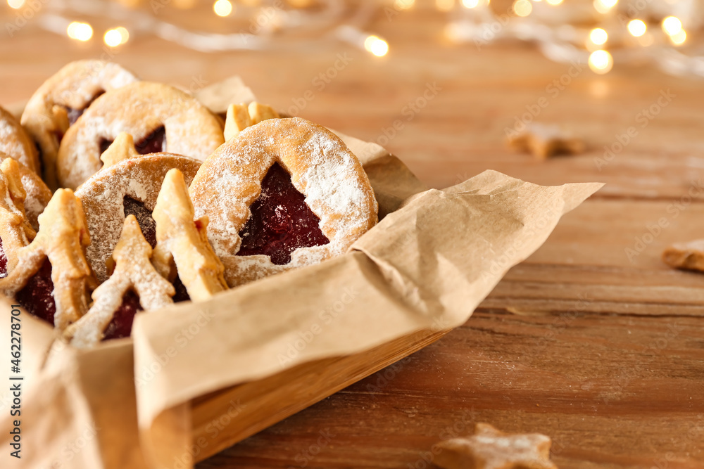 Box with tasty Linzer cookies on wooden table