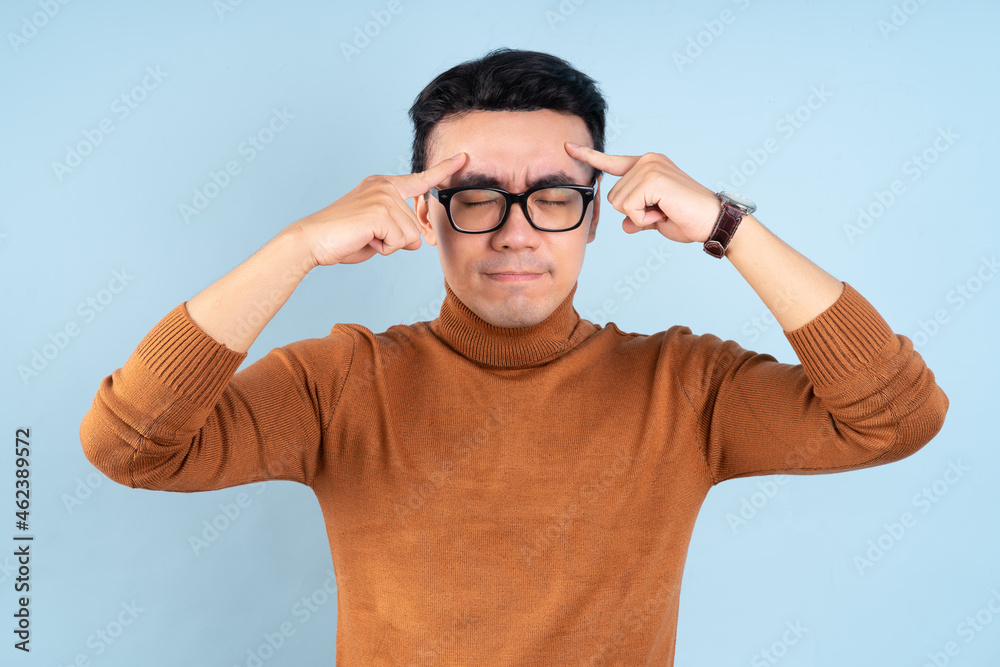 Asian man posing on blue background