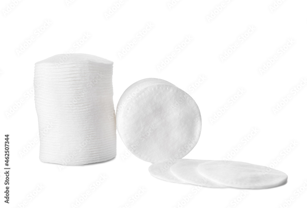 Stacks of clean cotton pads on white background