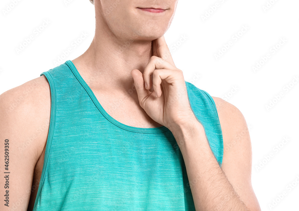 Sporty young man counting pulse on white background