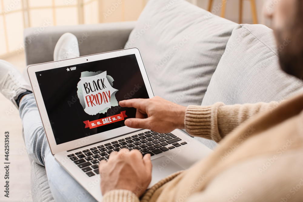 Young man shopping online on Black Friday at home