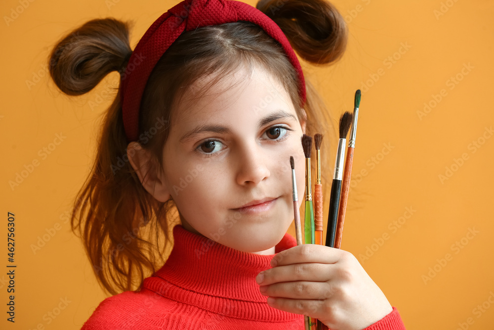 Cute little painter with brushes on color background