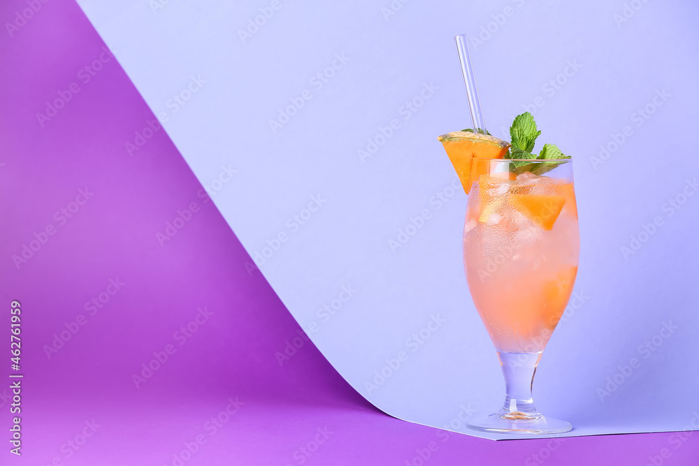 Glass of delicious melon cocktail on color background