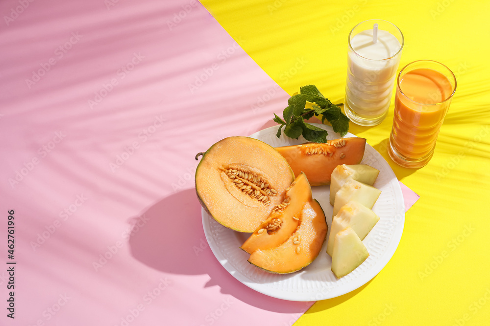 Glasses of tasty melon milkshake on color background