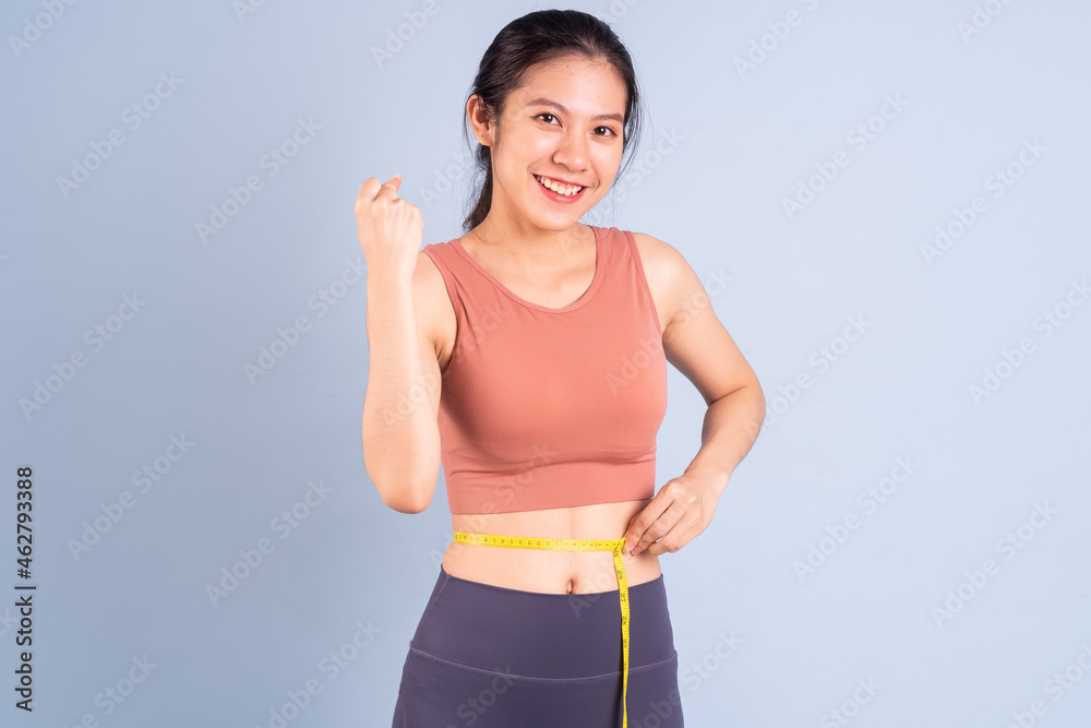 Beautiful Asian woman wearing sportswear and doing yoga, fitness and gym concept