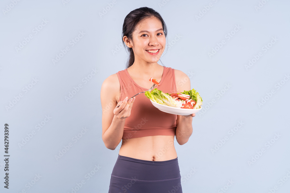 Beautiful Asian woman wearing sportswear and doing yoga, fitness and gym concept