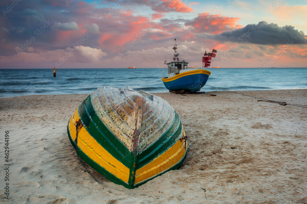 Amazing sunset with fishing boats at the beach of Baltic Sea in Sopot, Poland