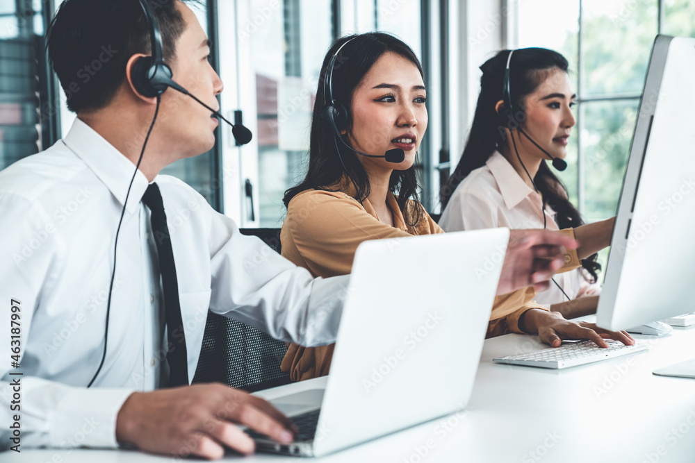 Business people wearing headset working actively in office . Call center, telemarketing, customer su