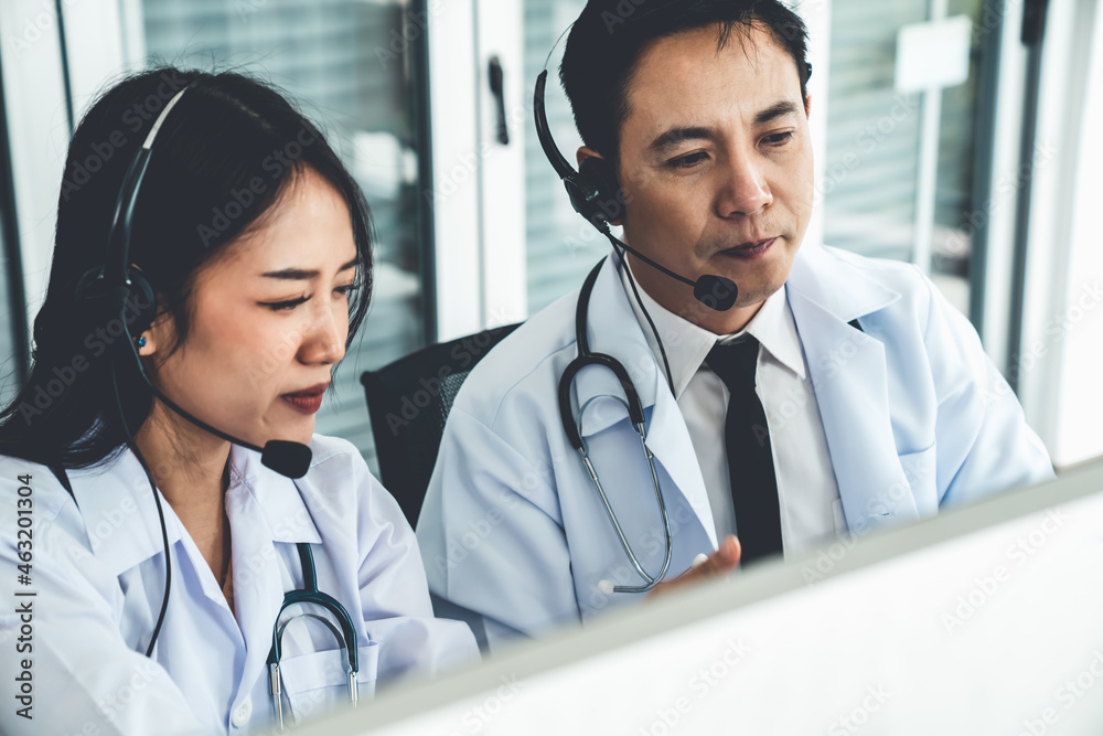 Doctor team wearing headset talking actively on video call in hospital clinic . Concept of telehealt