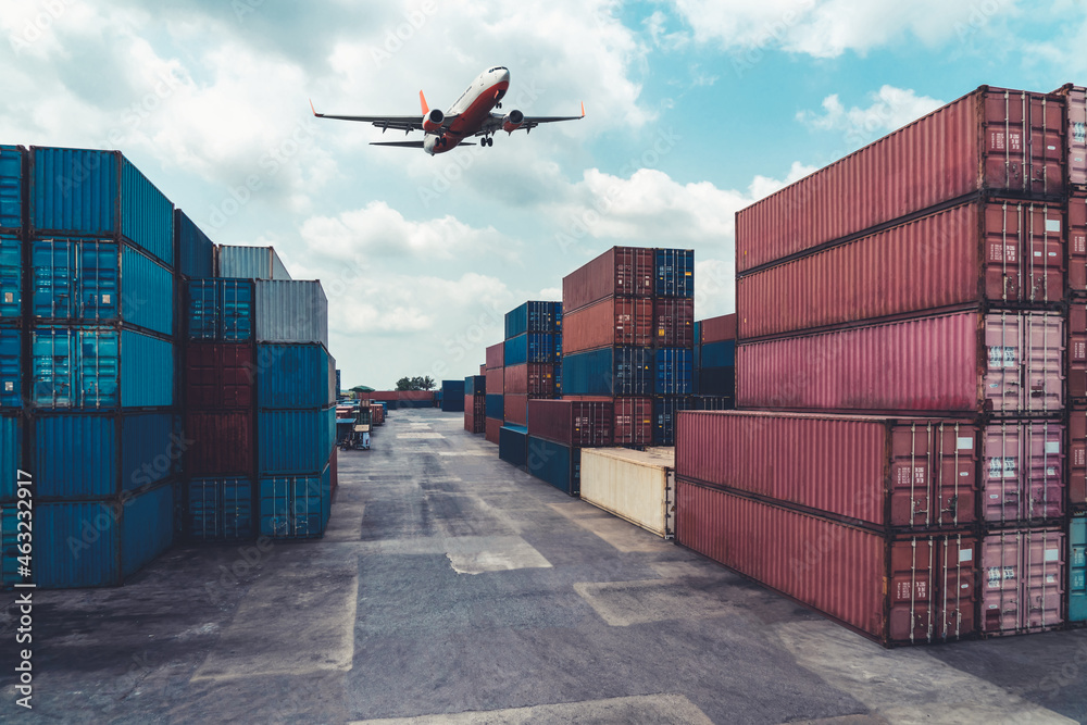 Cargo container for overseas shipping in shipyard with airplane in the sky . Logistics supply chain 