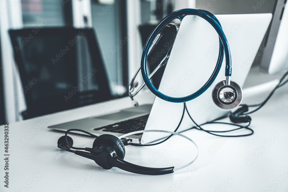 Headset and doctor equipment at clinic ready for actively support for patient by online video call .