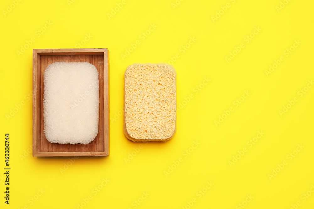 Different bath sponges on color background