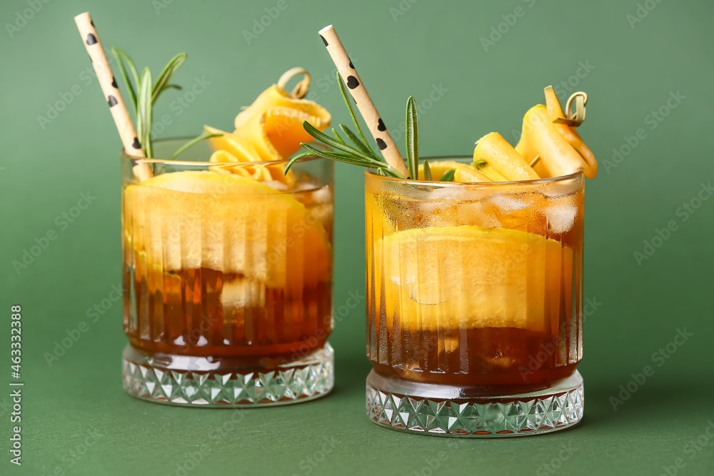 Glasses of cold melon cocktail on green background