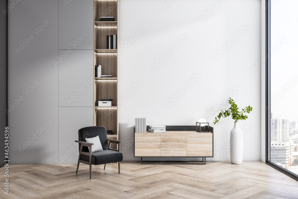 Modern interior with wooden flooring, bookcase, armchair, decorative plant and window with city view