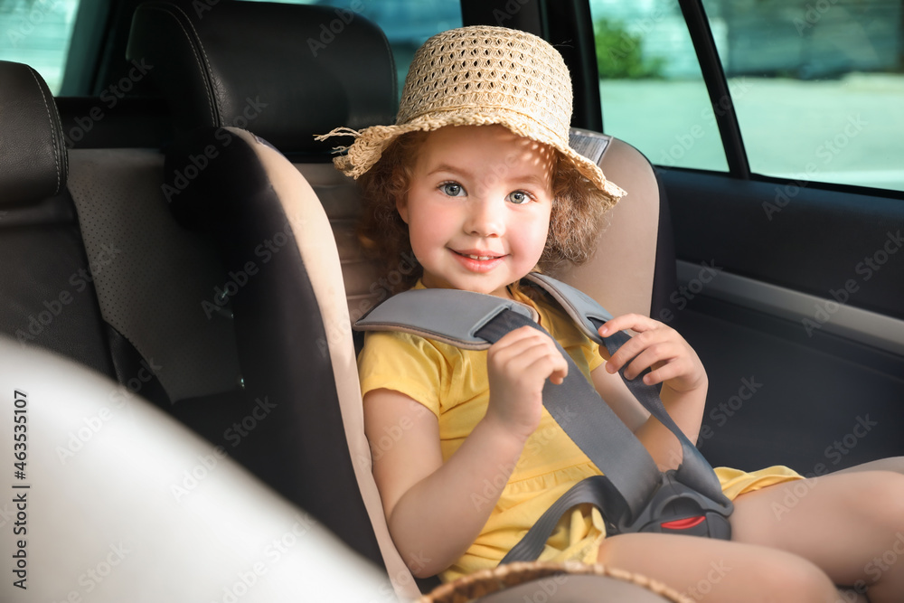 Cute little girl buckled in car safety seat