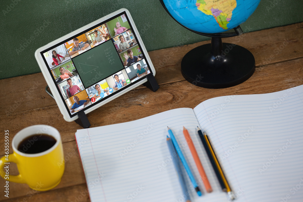 Smiling diverse elementary school pupils during class on tablet screen