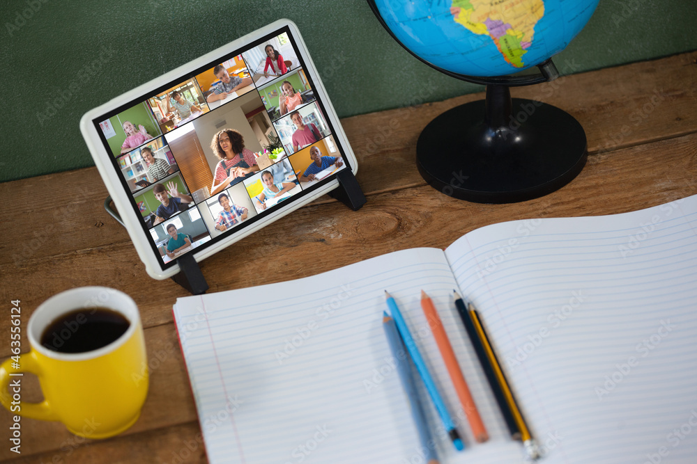 Smiling diverse elementary school pupils during class on tablet screen