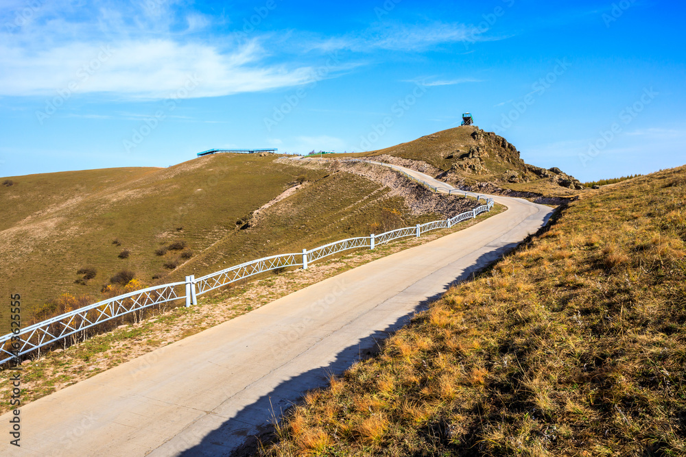 Curved road and mountain natural scenery in autumn season.Road and mountain background.