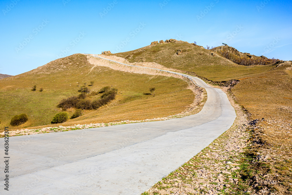 Curved road and mountain natural scenery in autumn season.Road and mountain background.