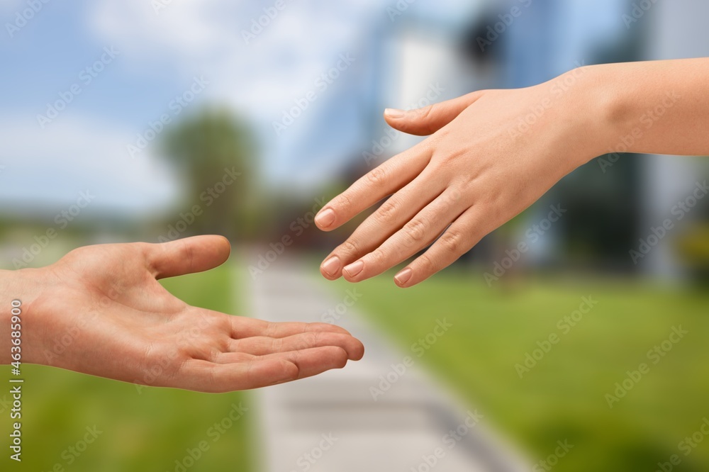 Hands of caregivers and the elderly human on a background