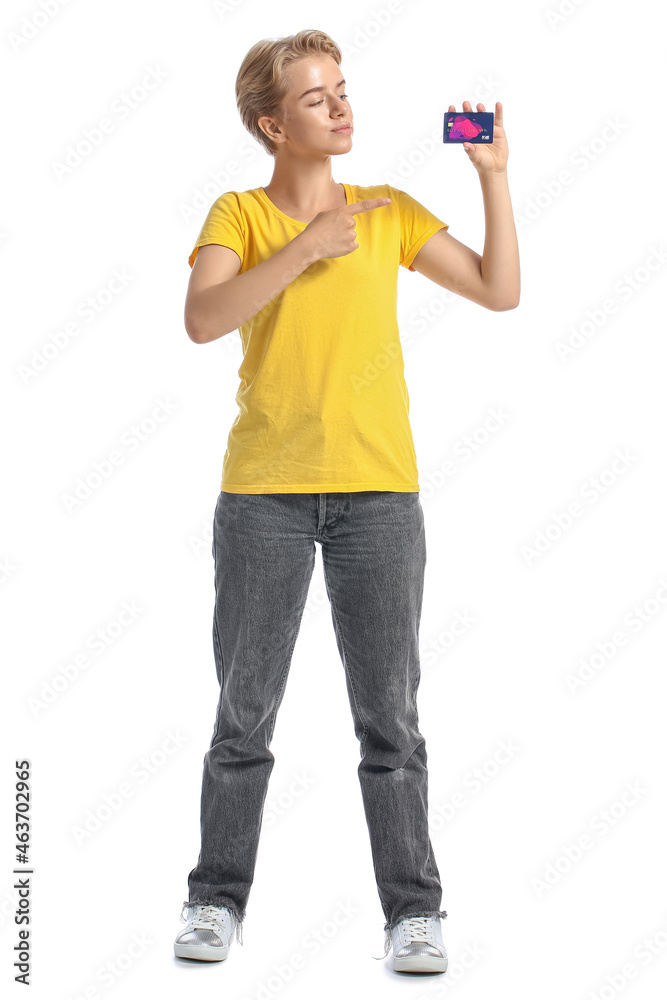 Young woman pointing at credit card on white background