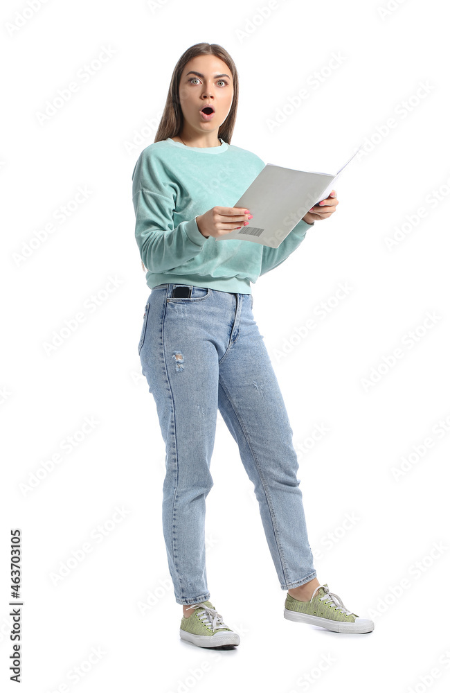 Shocked young woman reading magazine on white background