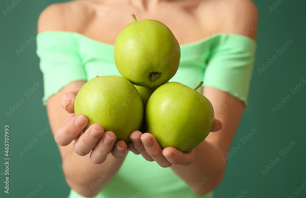 Young woman with apples on color background, closeup. Vegan Day