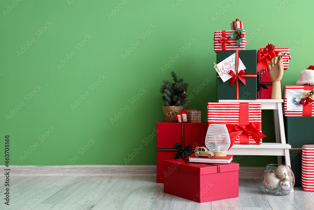 Beautiful Christmas gifts near color wall