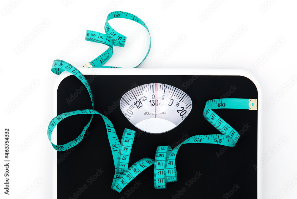 Weight scale and measure tape on white background with copy space , Weight loss or healthy diet cont