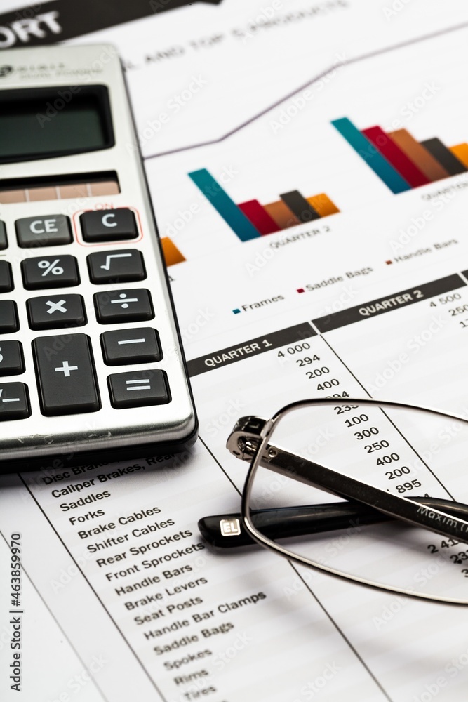 Calculator and Eyeglasses on Business Graphs