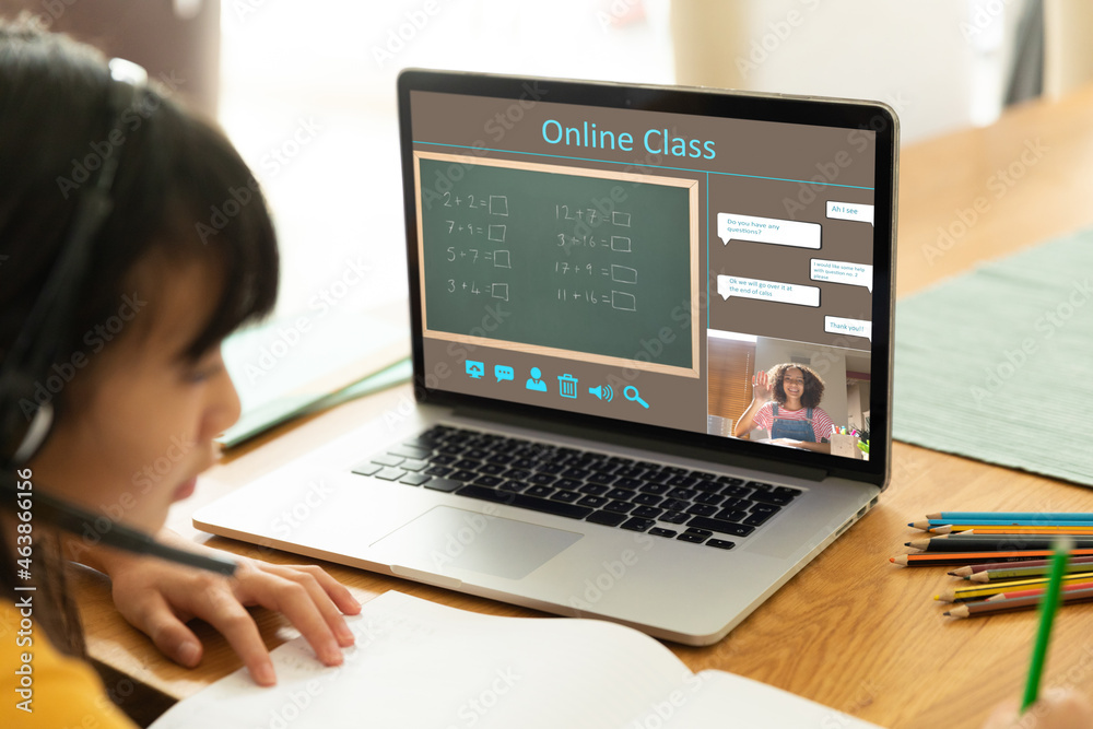 Asian girl using laptop for video call, with smiling biracial female teacher during class on screen