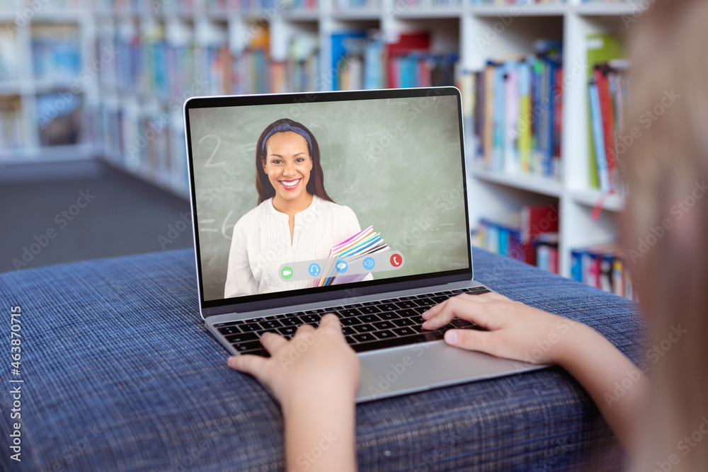 Caucasian girl using laptop for video call, with smiling female teacher on screen