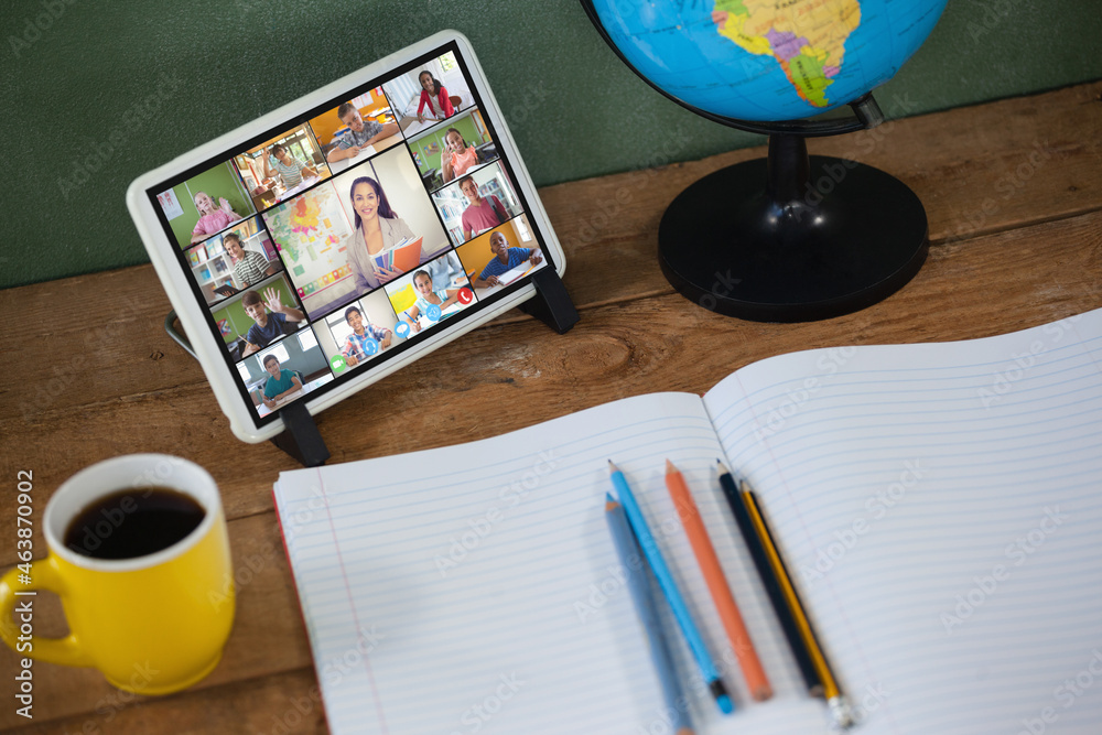 Smiling diverse elementary school pupils during class on tablet screen