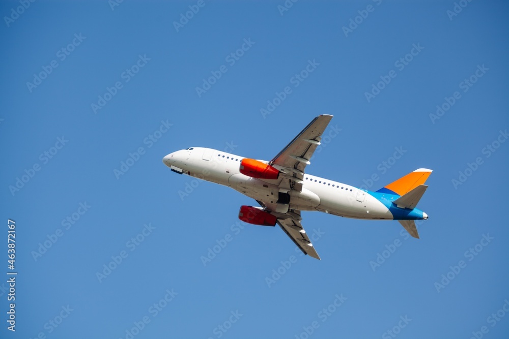 Airplane liner flying above in the beautiful sky. Travel concept.