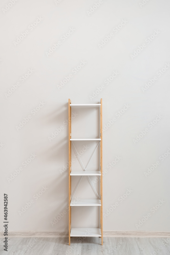 Stylish shelf unit near white wall