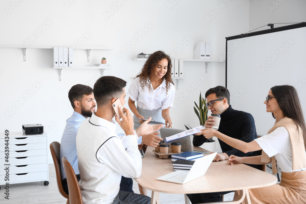 Young business colleagues working at table in office