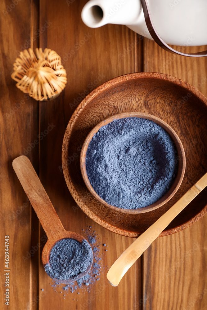 Composition with powdered blue matcha tea on wooden background